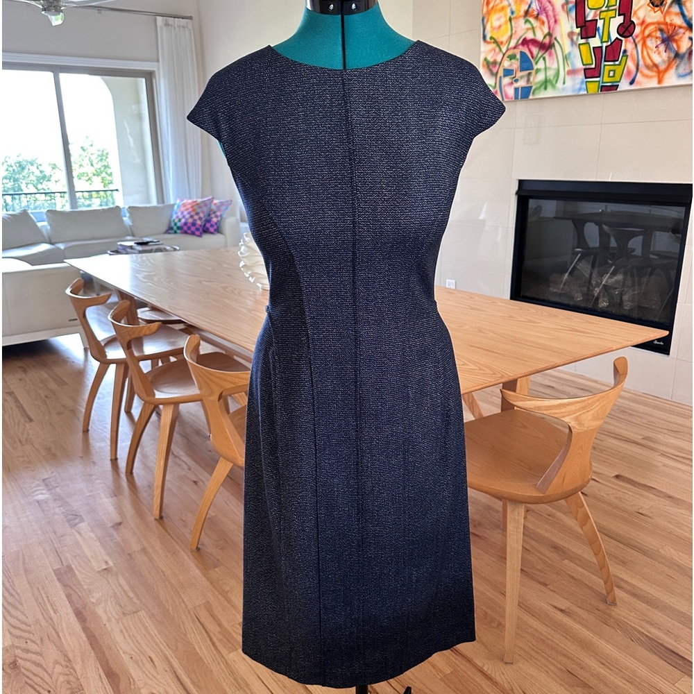 Blue with white specks below knee length sleeveless dress. Wool.